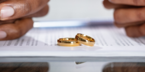 Two wedding ring son top of divorce paperwork