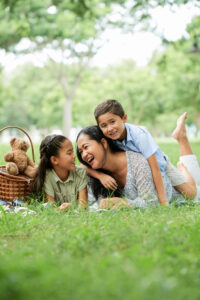 A mother having a picnic with her children outside